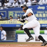 The Marines' Koki Yamaguchi hits a game-tying double against the Eagles in the fourth inning at Zozo Marine Stadium on Sunday. | KYODO