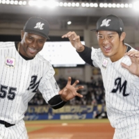 The Marines' Adeiny Hechavarria (left) and Toshiya Sato pose after their win over the Eagles in Game 1 of the Pacific League Climax Series first stage on Saturday in Chiba. | KYODO