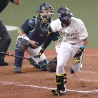 Yuma Mune hits a game-tying single against the Swallows in Game 1 of the Japan Series at Kyocera Dome Osaka on Saturday. | KYODO
