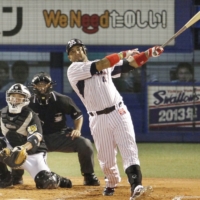 The Swallows' Wladimir Balentien connects on his record-breaking 56th home run of the season at Jingu Stadium on Sept. 15, 2013, at Jingu Stadium. | KYODO