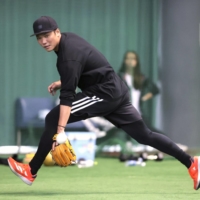 Giants shortstop Hayato Sakamoto fields a ball during a workout Naha on Jan. 12. | KYODO