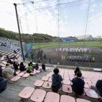 Spring training camp kicks off for the Yakult Swallows at an almost empty ballpark amid COVID-19 fears in the city of Urasoe, Okinawa Prefecture, on Tuesday. | KYODO 