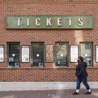 A woman walks past a ticket counter at Wrigley Field on the first day of the MLB lockout on Dec. 2, 2021. | USA TODAY / VIA REUTERS