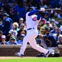 Chicago Cubs right fielder Seiya Suzuki hits a three-run home run in the first inning against the Milwaukee Brewers at Wrigley Field on Sunday. | USA TODAY / VIA REUTERS