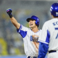 BayStars outfielder Toashi Ota celebrates knocking in a run in a game against the Hanshin Tigers at Yokohama Stadium on Thursday. | KYODO 