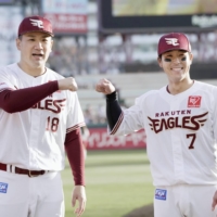 Rakuten's Masahiro Tanaka (left) and Daichi Suzuki celebrate after their win over Seibu in Sendai on Monday. | KYODO