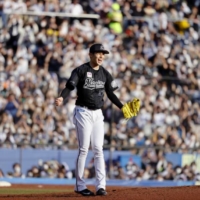 Lotte Marines pitcher Roki Sasaki reacts after throwing a perfect game against the Orix Buffaloes in a Pacific League baseball game at Zozo Marine Stadium in Chiba on Sunday | KYODO 