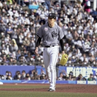 Marines starter Roki Sasaki returns to the bench after pitching eight perfect innings against the Fighters in Chiba on Sunday. | KYODO
