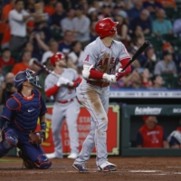 Los Angeles Angels' starting pitcher Shohei Ohtani (right) hits an RBI double during the first inning of a game against the Houston Astros at Minute Maid Park, in Houston, on Wednesday. | USA TODAY / VIA REUTERS