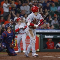 Los Angeles Angels' starting pitcher Shohei Ohtani (right) hits an RBI double during the first inning of a game against the Houston Astros at Minute Maid Park, in Houston, on Wednesday. | USA TODAY / VIA REUTERS