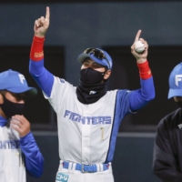 Fighters manager Tsuyoshi Shinjo celebrates after the team's won over the Lions at Sapporo Dome on Thursday night. | KYODO