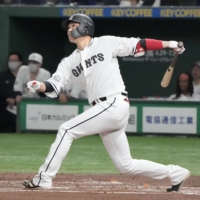 Hayato Sakamoto hits a two-run home run for the Giants in the first inning at Tokyo Dome on Saturday afternoon. | KYODO
