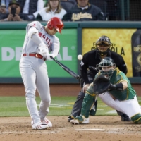 Shohei Ohtani hits his 100th-career MLB home run against the Athletics in Oakland, California, on Saturday. | KYODO