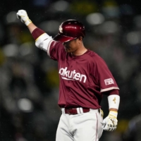 The Eagles' Ginji Akaminai celebrates after his tiebreaking single against the Tigers in the ninth inning at Koshien Stadium on Thursday. | KYODO