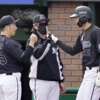 Hiromi Oka is congratulated by starter Manabu Mima after hitting a two-run home run against the Eagles in Sendai on Thursday. | KYODO