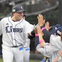 Hotaka Yamakawa celebrates with his teammates after a two-run home run against the Fighters at Belluna Dome in Tokorozawa, Saitama, Prefecture, on Sunday. | KYODO