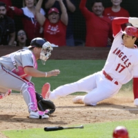 The Angels' Shohei Ohtani slides home to score the winning run against the Nationals in Anaheim, California, on Sunday. | KYODO