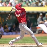 The Angels' Shohei Ohtani connects on a two-run home run in the first inning against the Athletics in Oakland on Sunday. | KYODO