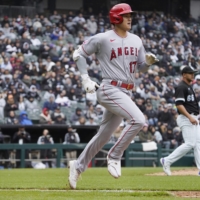 Shohei Ohtani runs to first during the seventh inning of the Angels' game against the White Sox in Chicago on Sunday. | USA TODAY / VIA REUTERS