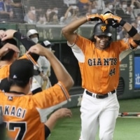 Adam Walker celebrates with his teammates after hitting a tiebreaking home run in the seventh inning at Tokyo Dome on Wednesday. | KYODO