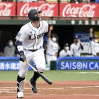 The Lions' Brian O'Grady hits a home run against the Carp during the fourth inning at Belluna Dome in Tokorozawa, Saitama Prefecture, on Sunday. | KYODO