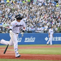 Munetaka Murakami hits a two-run home run for the Swallows against the Lions at Tokyo's Jingu Stadium on Saturday. | KYODO
