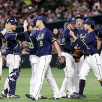 Yakult celebrates after clinching this year's interleague title with a win over SoftBank in Fukuoka on Saturday. | KYODO