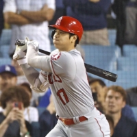 The Angels' Shohei Ohtani triples against the Dodgers in the top of the ninth at Dodger Stadium on Wednesday. | KYODO