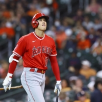 The Angels' Shohei Ohtani returns to the dugout after striking out against the Astros during the eighth inning in Houston on Sunday. | KYODO