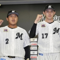 Marines ace Roki Sasaki (right) and battery partner Ko Matsukawa pose for photos at a news conference announcing their selection to the Pacific League's squad for the upcoming NPB All-Star Games in Chiba on Wednesday. | KYODO