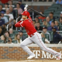 Angels designated hitter Shohei Ohtani hits his 20th home run of the season against the Braves in Atlanta on Saturday. | KYODO