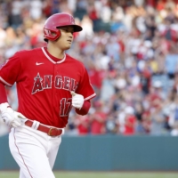 Shohei Ohtani rounds third base after hitting his 22nd home run of the season against the Rangers in Anaheim, California, on Saturday. | KYODO