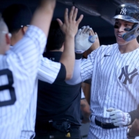 Aaron Judge (right) celebrates in the dugout after hitting his 200th career home run against the Royals in New York on Saturday. | USA TODAY / VIA REUTERS