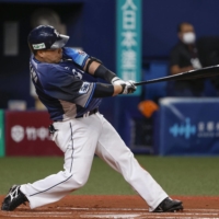 The Lions' Hotaka Yamakawa connects on an RBI single against the Buffaloes in Osaka on Sunday. | KYODO