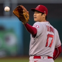Angels starting pitcher Shohei Ohtani catches the ball during the third inning against the Athletics in Oakland, California, on Tuesday. | USA TODAY / VIA REUTERS