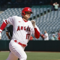 Shohei Ohtani hits an RBI triple against the Mariners during the seventh inning in Anaheim, California, on Wednesday. | KYODO
