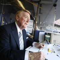 Vin Scully prepares for the start of the 2006 NLDS between the Dodgers and the Mets at Shea Stadium in New York. | ANDREW GOMBERT / THE NEW YORK TIMES