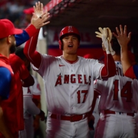 Shohei Ohtani returns to the dugout after scoring against the A's in Anaheim, California, on Wednesday. | USA TODAY / VIA REUTERS