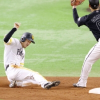 SoftBank's Masaki Mimori (left) steals second base during the team's win against the Marines in Fukuoka on Monday. | KYODO