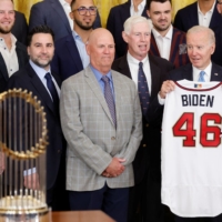 U.S. President Joe Biden receives a uniform from the 2021 World Series champion Atlanta Braves during their visit to the White House in Washington on Monday. | REUTERS