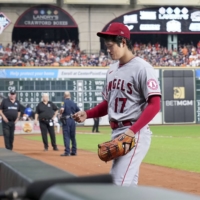 Shohei Ohtani leaves the game before the start of the sixth inning after evaluating a blister on his pitching hand during the Angels' game against the Astros in Houston on Saturday. | KYODO