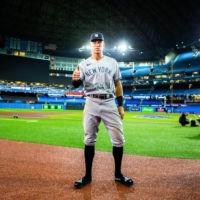 New York Yankees outfielder Aaron Judge conducts postgame interviews after hitting his 61st home run of the season, at the Rogers Centre in Toronto on Wednesday. | CHRIS DONOVAN / THE NEW YORK TIMES