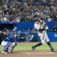 Aaron Judge hits his 61st home run of the season during the seventh inning against the Blue Jays in Toronto on Wednesday. | USA TODAY / VIA REUTERS