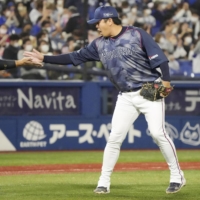 BayStars Yasuaki Yamasaki (right) celebrates with catcher Hiroki Minei after notching his 36th save to defeat the Giants at Yokohama Stadium on Thursday. | KYODO