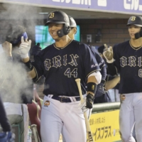 The Buffaloes' Yuma Tongu returns to the bench after hitting a three-run home run against the Eagles in Sendai on Wednesday. | KYODO