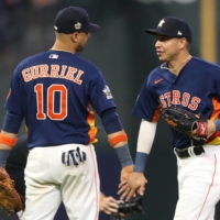 Astros first baseman Yuli Gurriel (left) and shortstop Jeremy Pena celebrate after beating the Phillies in Game 2 of the World Series in Houston on Saturday. | USA TODAY / VIA REUTERS