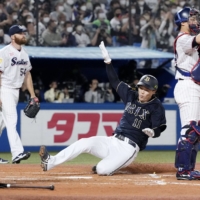 Buffaloes pitcher Sachiya Yamasaki slides home to score his team's second run during the third inning in Game 2 of the Japan Series at Jingu Stadium on Sunday. | KYODO