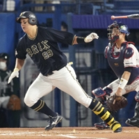 The Buffaloes' Yutaro Sugimoto connects on an RBI single against the Swallows in the sixth inning in Game 6 of the Japan Series at Jingu Stadium on Saturday. | KYODO