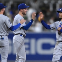 Mookie Bets (right) and Trea Turner (center) are among a strong Dodgers roster that claimed the team's ninth NL West title in 10 years this season. | USA TODAY / VIA RETUERS