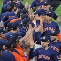 Houston Astros players and coaches celebrate on the field after defeating the New York Yankees in Game 2 of the ALCS for the 2022 MLB Playoffs at Minute Maid Park in Houston on Thursday. | USA TODAY / VIA REUTERS